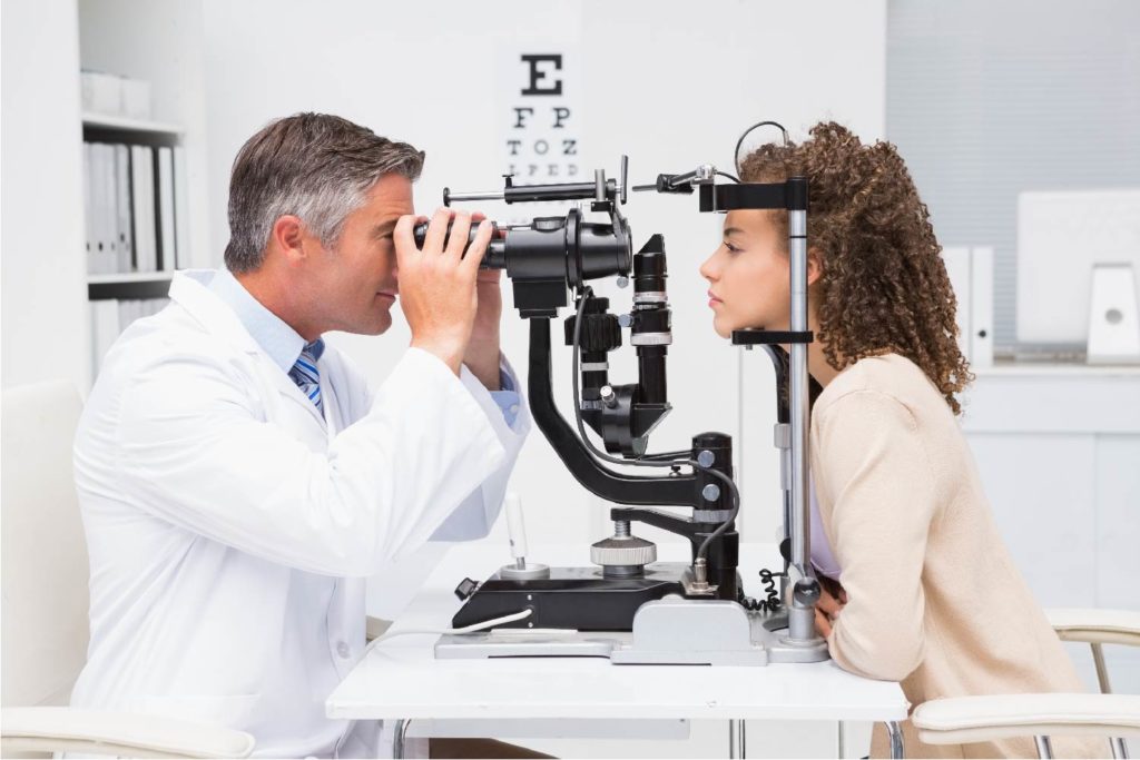 Can My Eyesight Get Better? woman at the eye doctor having an eye exam
