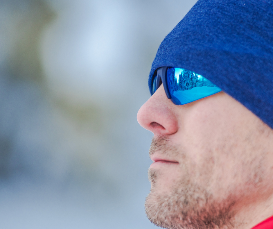 A man wearing suglasses in winter.