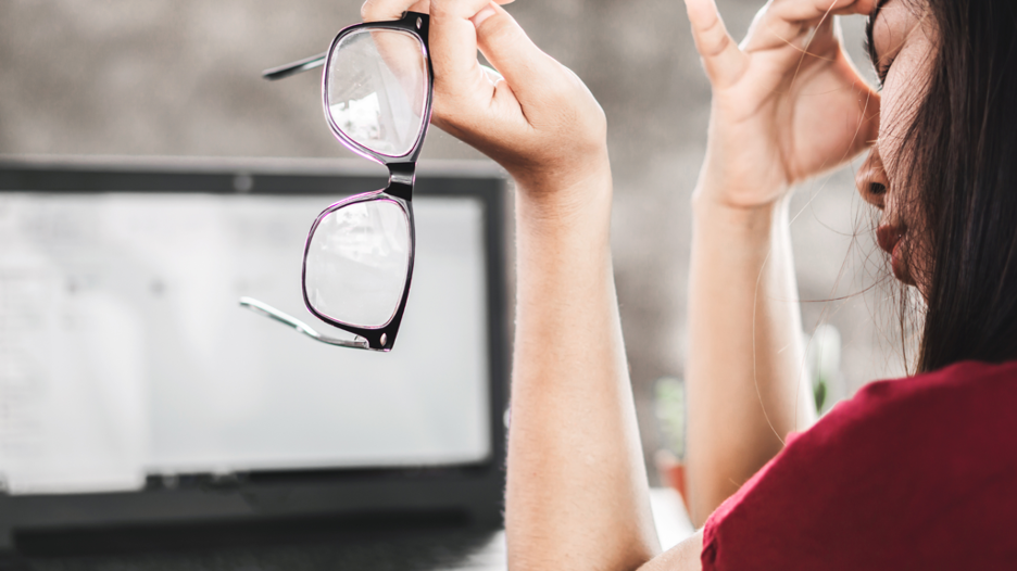 Female at workspace wearing glasses